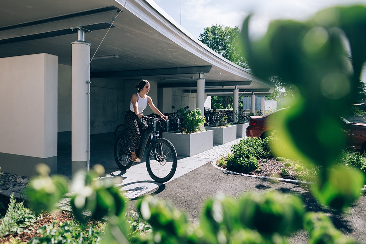 Mitarbeiterin sitzt auf Ihrem geleasten Wunschfahrrad und nutzt das Job Rad-Angebot.